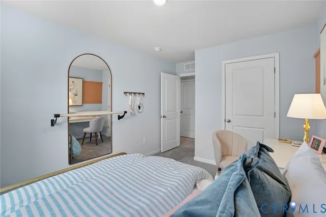 a bedroom with a bed and a mirror