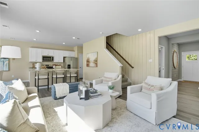 a living room with furniture and kitchen view