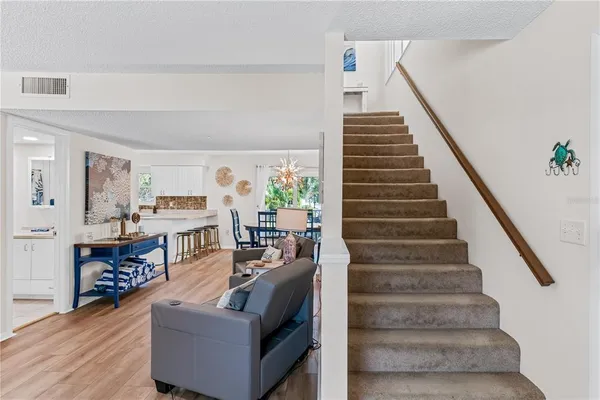 a living room with furniture and stairs