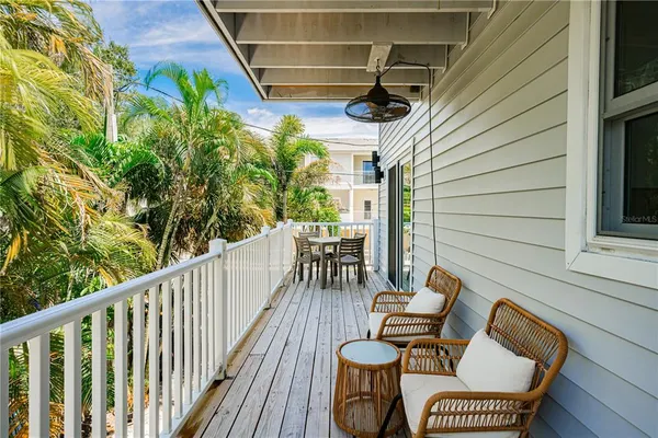 a view of a chairs and table in the balcony
