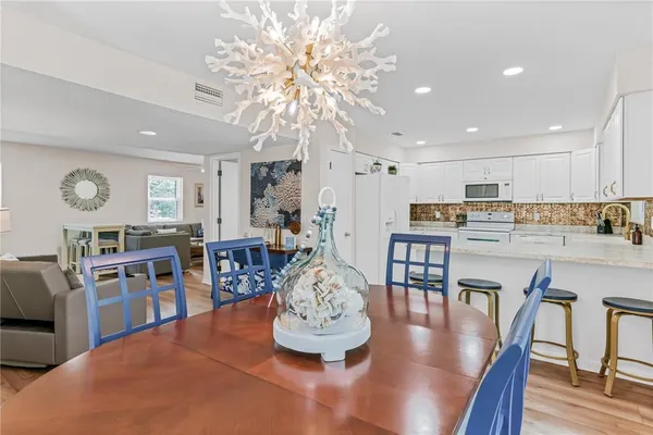 a living room with dining room and wooden floor