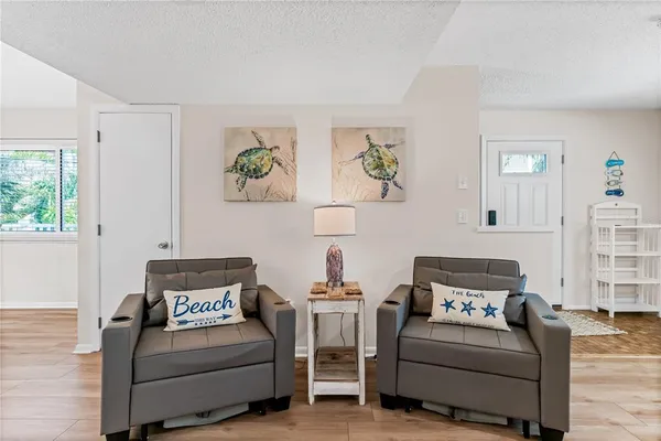 a living room with furniture and painting on the wall