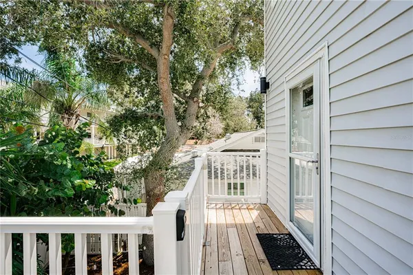 a view of a balcony with wooden floor