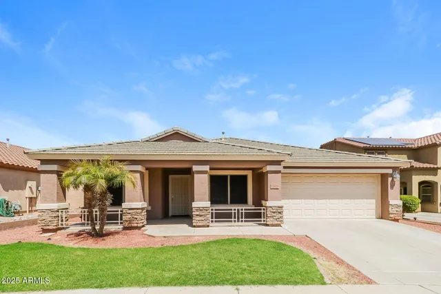 front view of a house with a garden and patio
