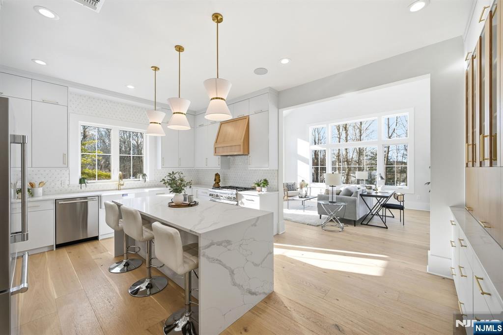 8 Montgomery Road Livingston, NJ 07039 - Photo 11 of 38 a kitchen with a sink a counter top space and living room view
