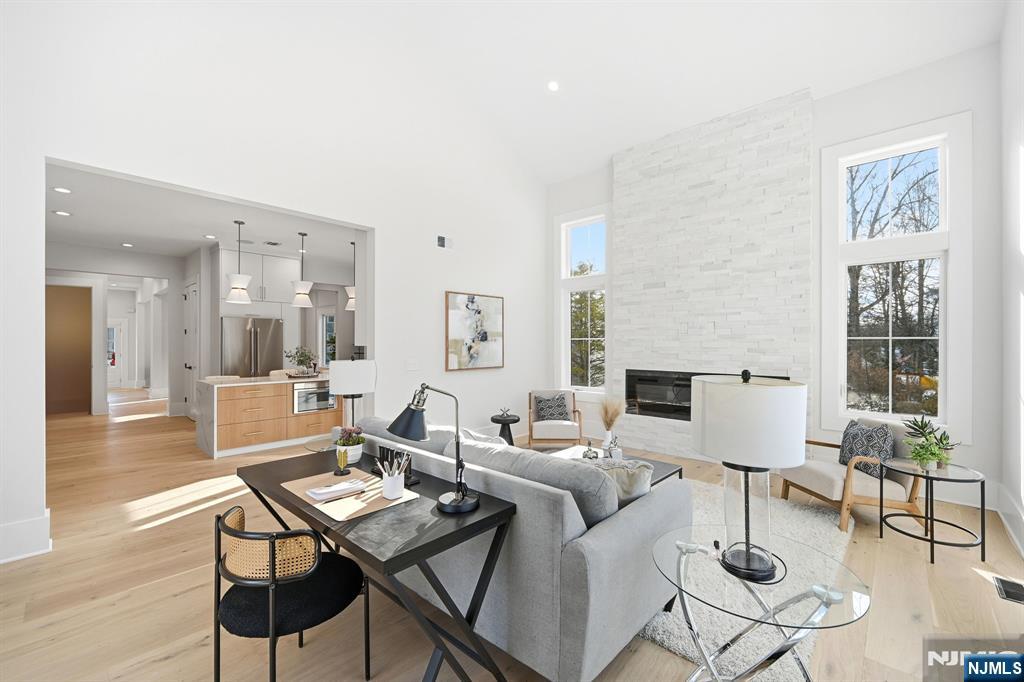 8 Montgomery Road Livingston, NJ 07039 - Photo 13 of 38 a living room with fireplace furniture and a table