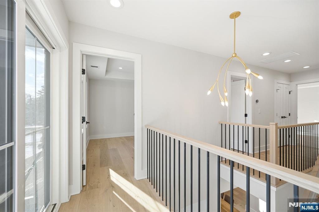 8 Montgomery Road Livingston, NJ 07039 - Photo 23 of 38 a view of a hallway with windows and stairs