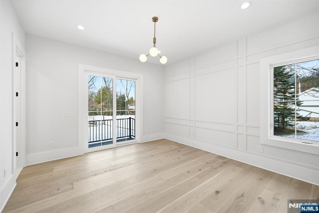 8 Montgomery Road Livingston, NJ 07039 - Photo 27 of 38 an empty room with wooden floor cabinet and windows