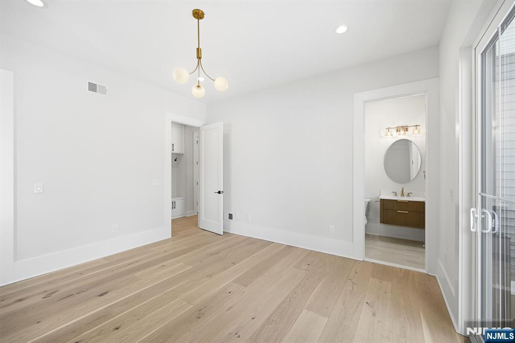 8 Montgomery Road Livingston, NJ 07039 - Photo 28 of 38 wooden floor in an empty room with a window