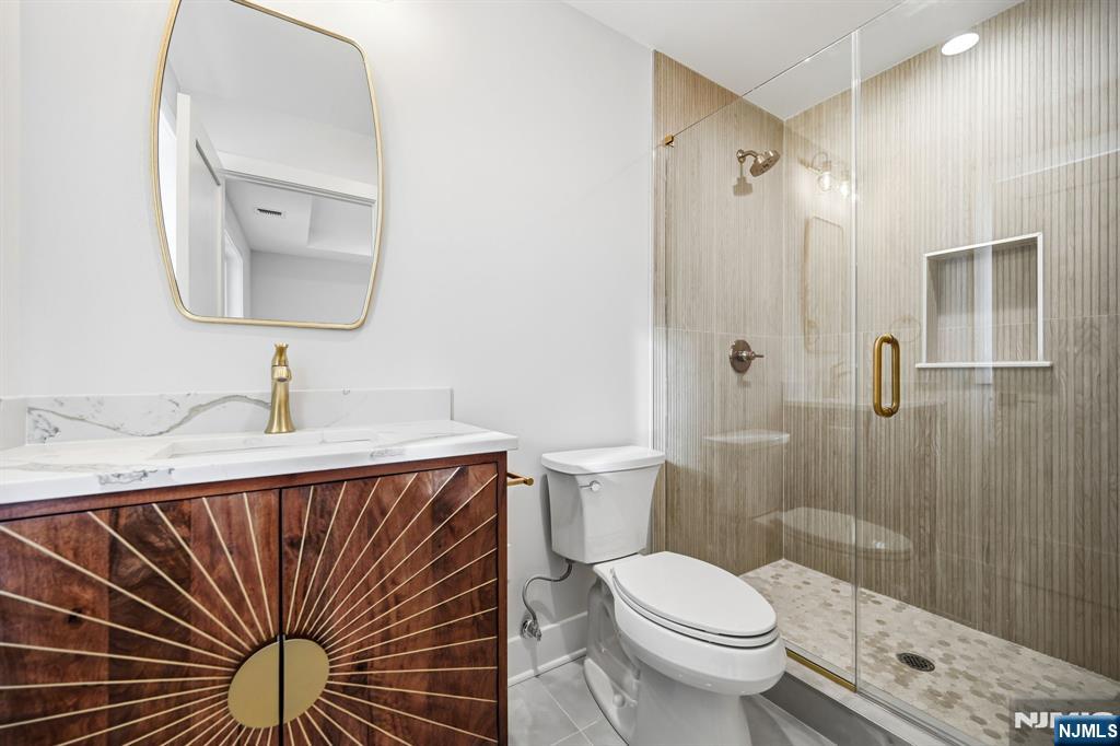 8 Montgomery Road Livingston, NJ 07039 - Photo 30 of 38 a bathroom with a sink a toilet and shower