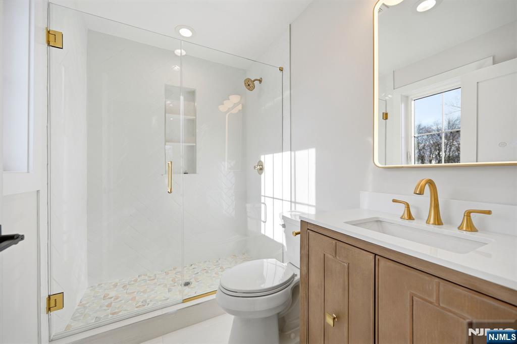 8 Montgomery Road Livingston, NJ 07039 - Photo 32 of 38 a bathroom with a sink toilet and shower