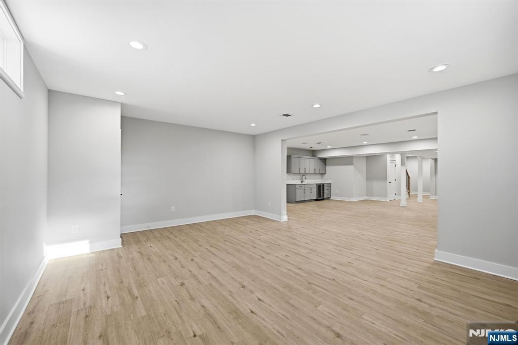 8 Montgomery Road Livingston, NJ 07039 - Photo 35 of 38 a view of empty room with wooden floor and kitchen