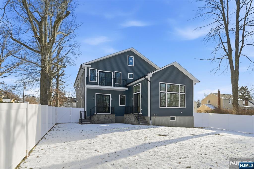 8 Montgomery Road Livingston, NJ 07039 - Photo 38 of 38 a front view of a house with a yard and garage