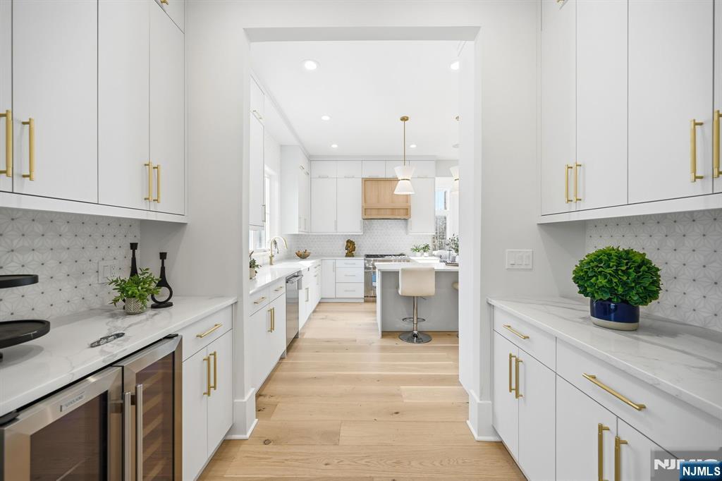 8 Montgomery Road Livingston, NJ 07039 - Photo 7 of 38 a kitchen with counter top space a sink stainless steel appliances and cabinets