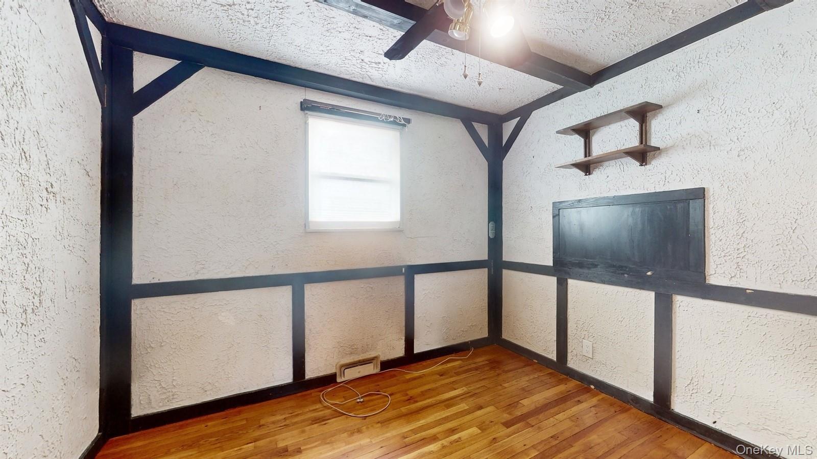 10 Rumbrook Road Elmsford, NY 10523 - Photo 12 of 25 Unfurnished bedroom with hardwood / wood-style flooring, ceiling fan, and beam ceiling