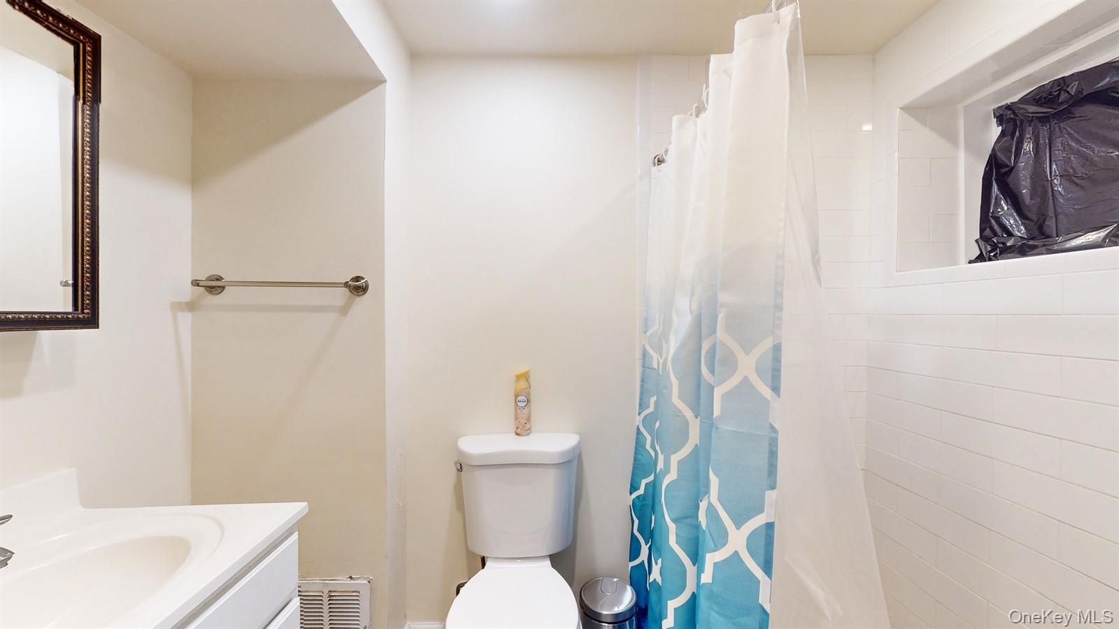 10 Rumbrook Road Elmsford, NY 10523 - Photo 17 of 25 Bathroom featuring vanity, a shower with shower curtain, and toilet