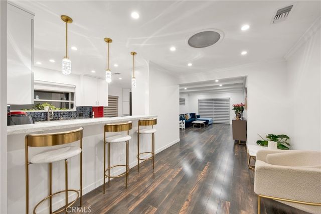 a kitchen with counter top space view and living room view