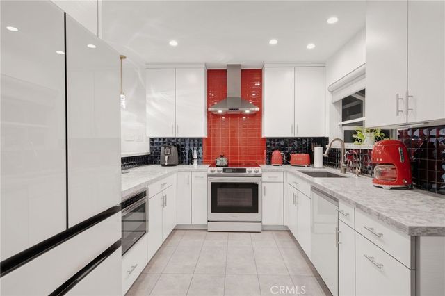 a kitchen with stainless steel appliances kitchen island granite countertop a sink and cabinets