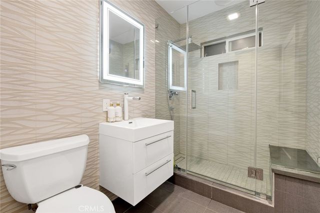 a bathroom with a toilet sink and shower