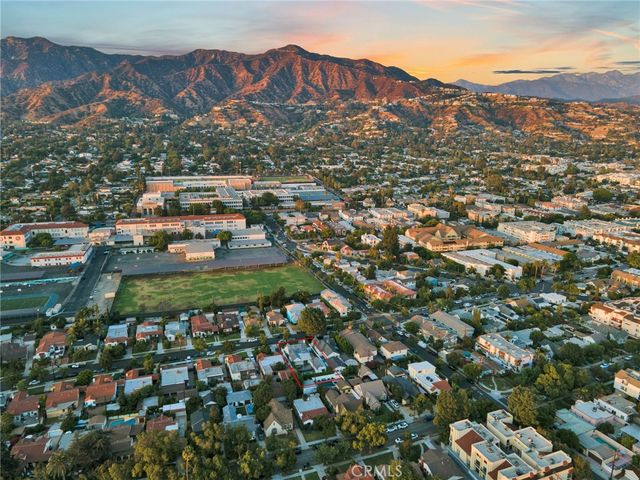 an aerial view of a house with a swimming pool and outdoor seating