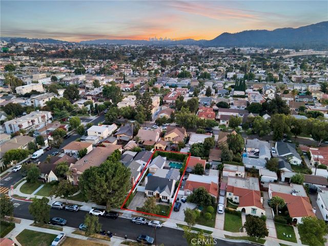 an aerial view of residential houses with city view