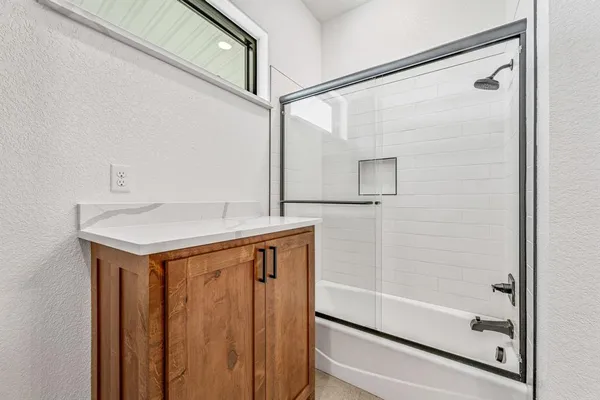 a bathroom with a shower and sink