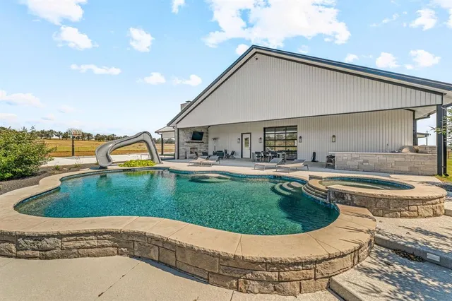 an aerial view of a house with a swimming pool