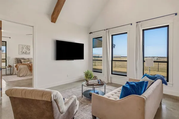 a living room with furniture and a flat screen tv