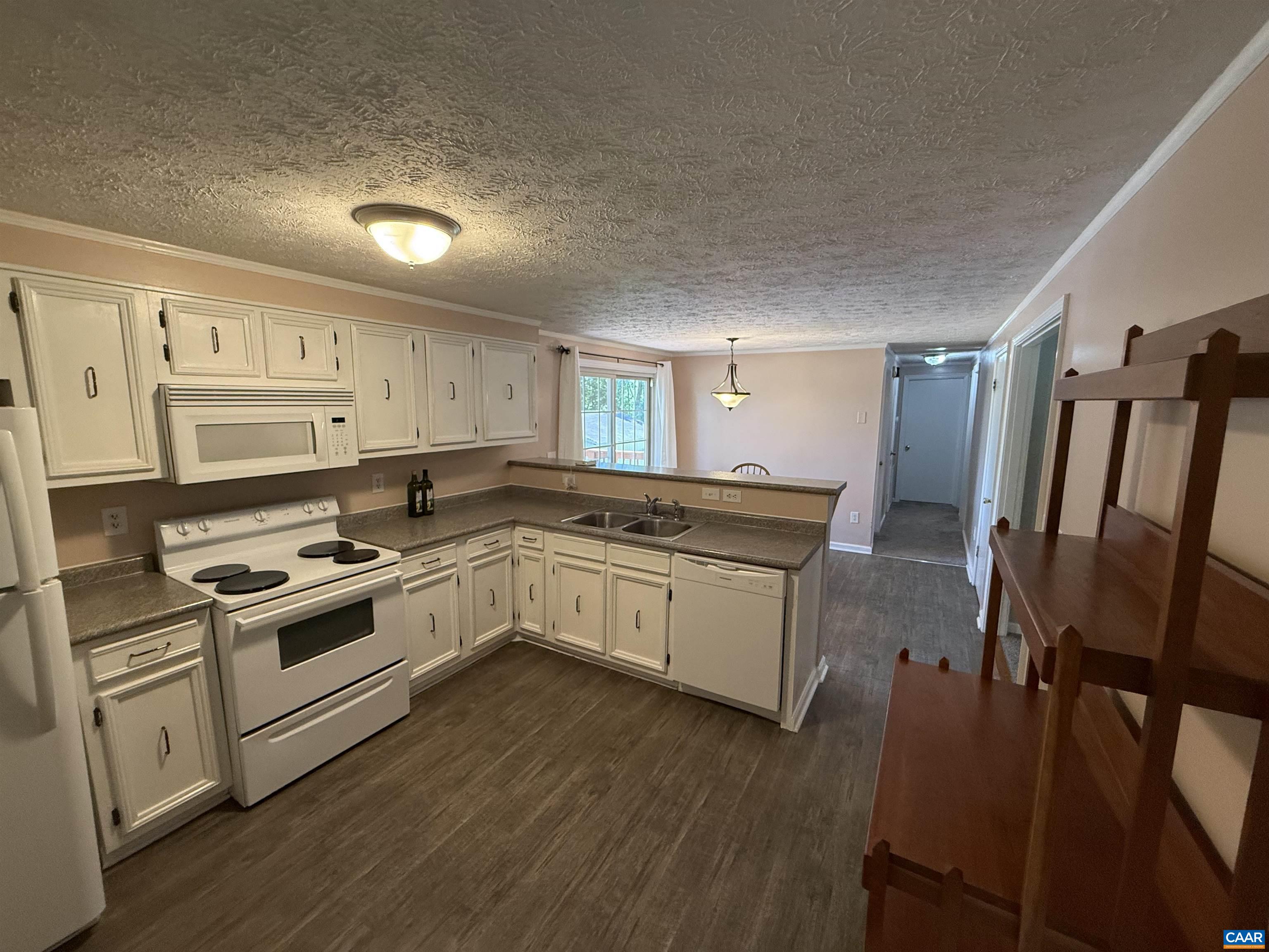 2002 Oliver Creek Road Troy, VA 22974 - Photo 8 of 38 a kitchen with granite countertop white cabinets and white appliances