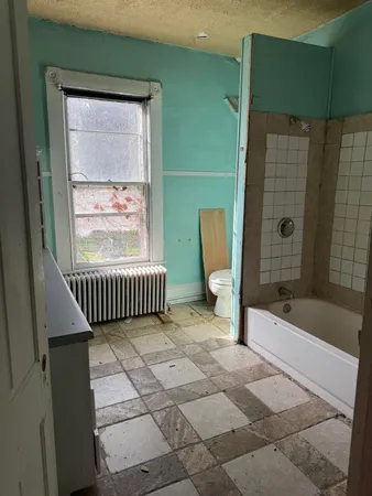 a bathroom with a bathtub and a shower