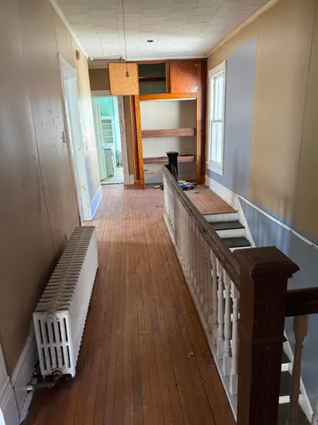 a kitchen with granite countertop a stove and a wooden floor