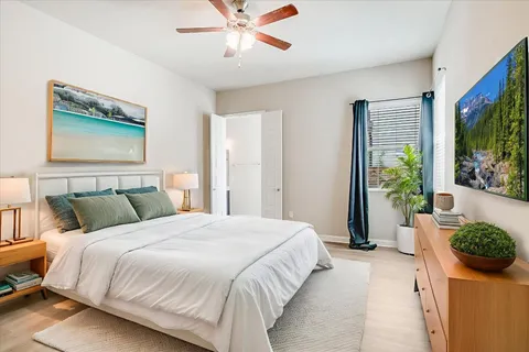 a bedroom with a bed and a painting on the wall