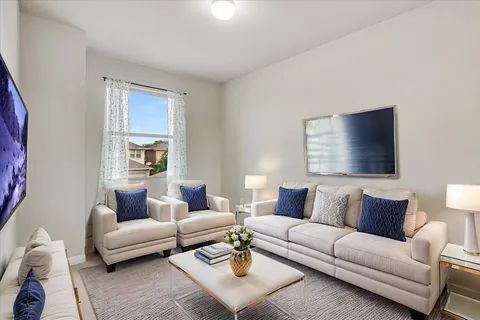 a living room with furniture and a large window