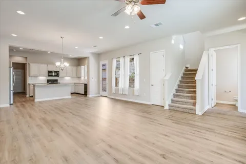 a view of a kitchen with furniture and wooden floor