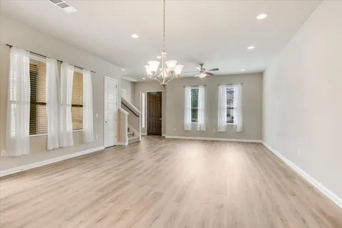 a view of a livingroom with a ceiling fan and window