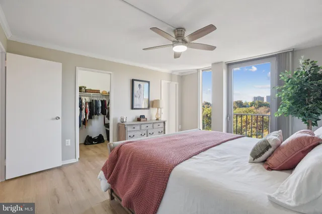 a bedroom with a large bed and a chandelier