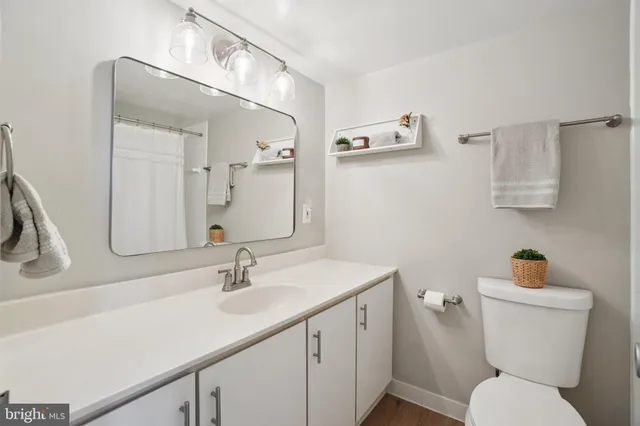 a bathroom with a sink a toilet and mirror