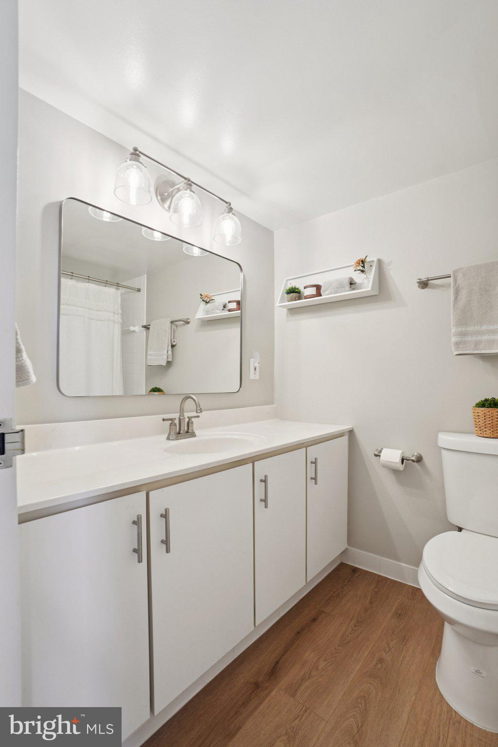 4600 South Four Mile Run Drive, Unit 842 Arlington, VA 22204 - Photo 17 of 24 a spacious bathroom with a granite countertop sink a toilet and a mirror