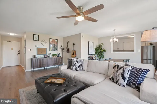 a living room with furniture and a wooden floor