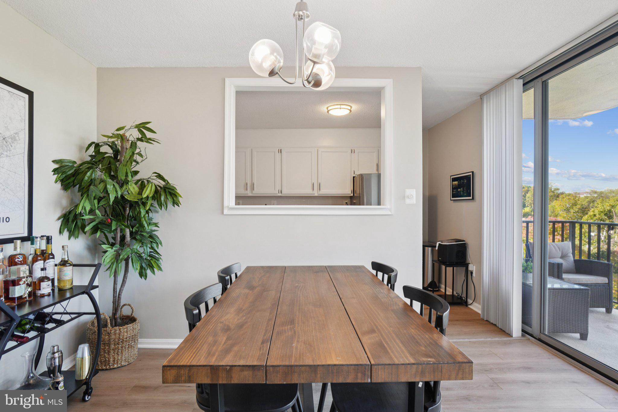 4600 South Four Mile Run Drive, Unit 842 Arlington, VA 22204 - Photo 5 of 24 a dining room with wooden floor a glass table and chairs