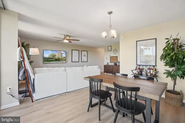 a view of a dining room with furniture and a chandelier