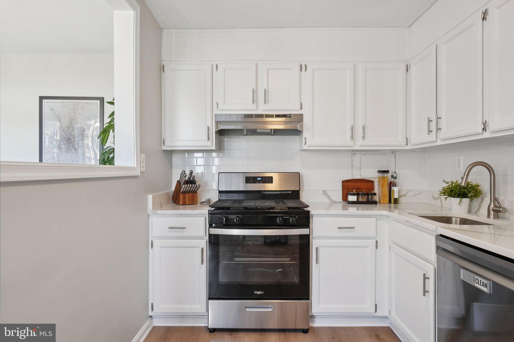 4600 South Four Mile Run Drive, Unit 842 Arlington, VA 22204 - Photo 9 of 24 a kitchen with white cabinets and appliances