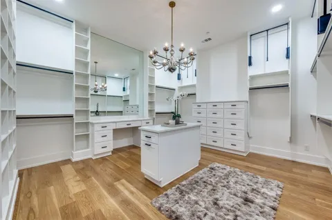 a kitchen with stainless steel appliances kitchen island granite countertop a sink stove and refrigerator
