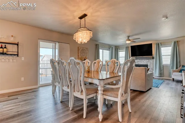 a view of a dining room with furniture wooden floor and chandelier