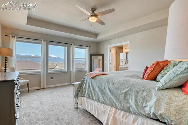 a bedroom with a bed dresser and a large window