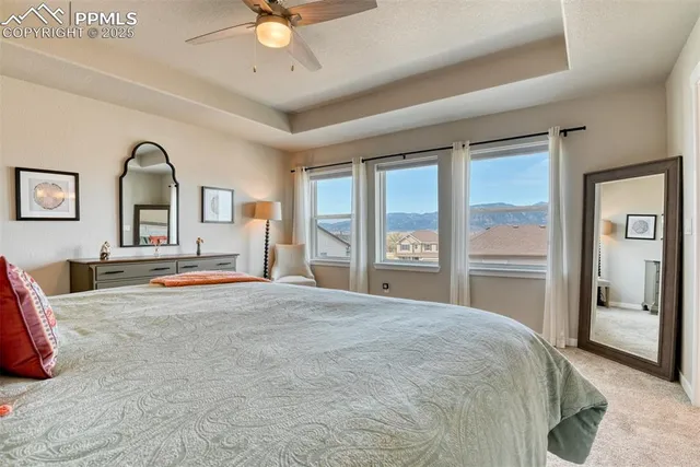 a bedroom with a large bed and a chandelier