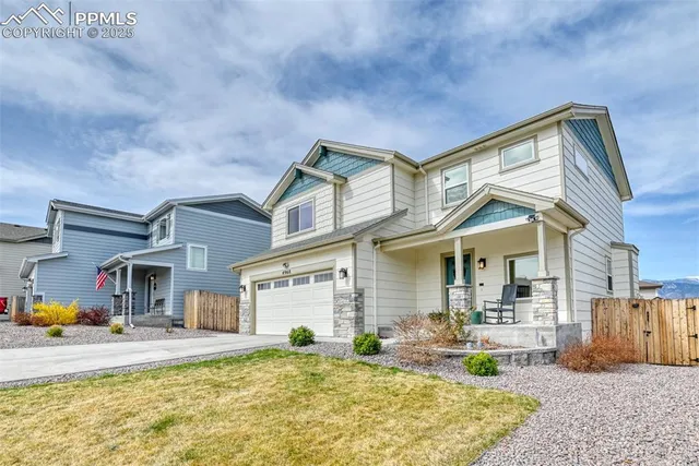a front view of a house with swimming pool having outdoor seating