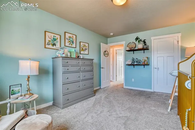a view of a bedroom with baby bed and toys