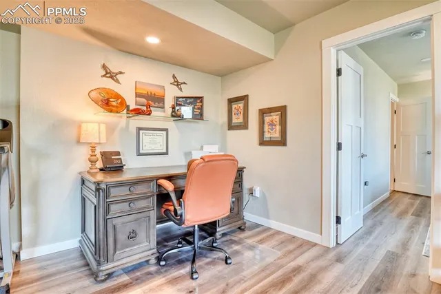 a view of a workspace with furniture and a workspace