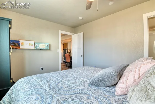 a bedroom with a bed and painting on the wall